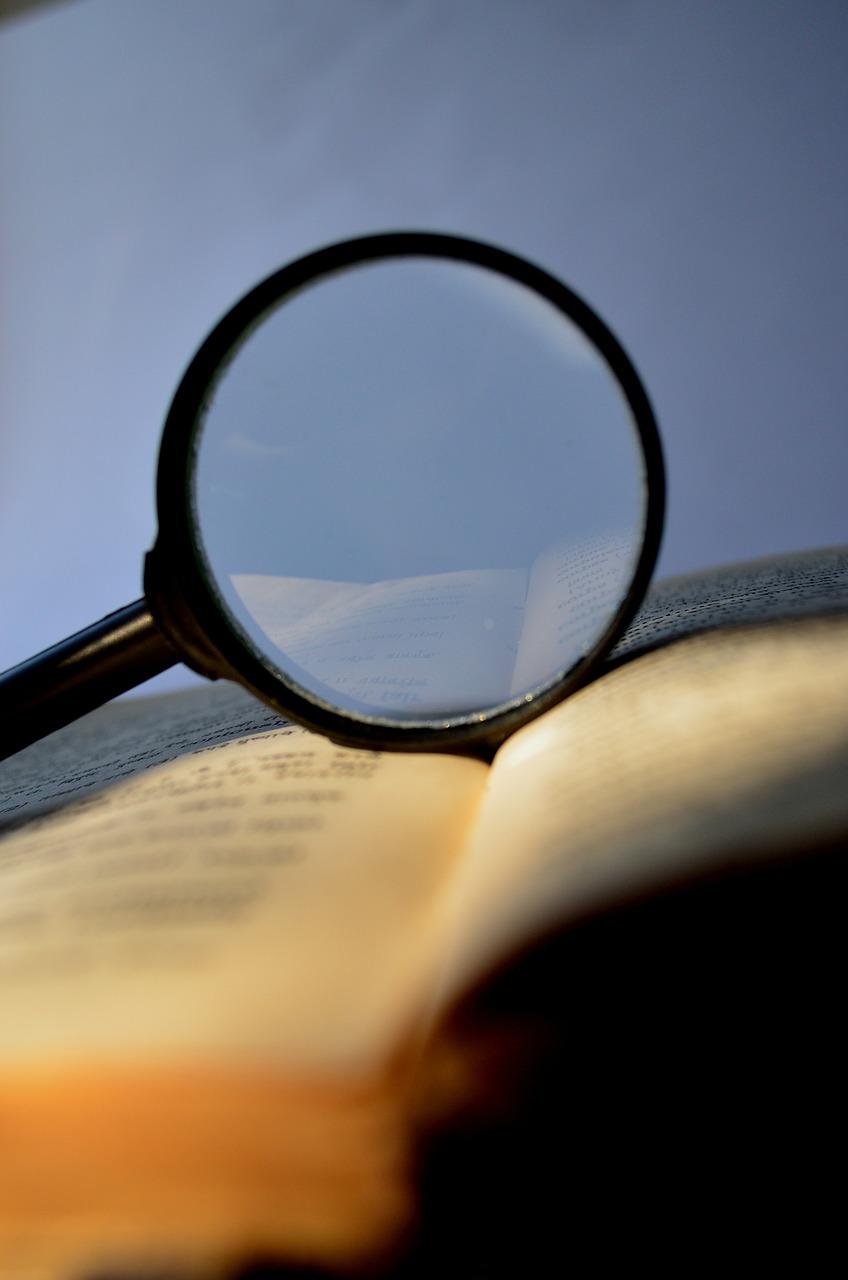 Magnifying glass resting on a book