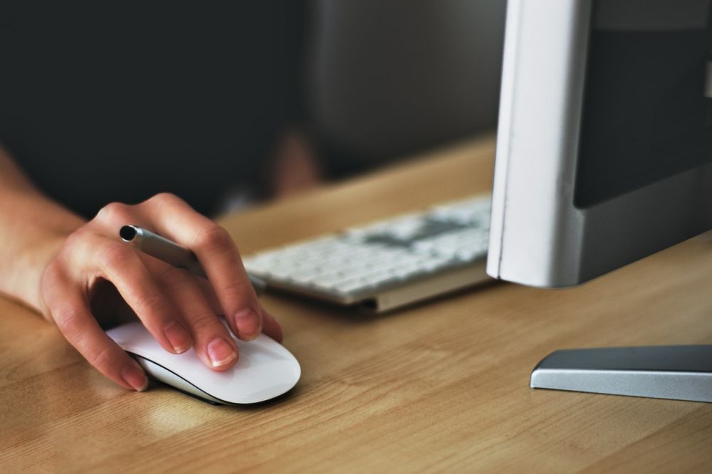 Person clicking a mouse